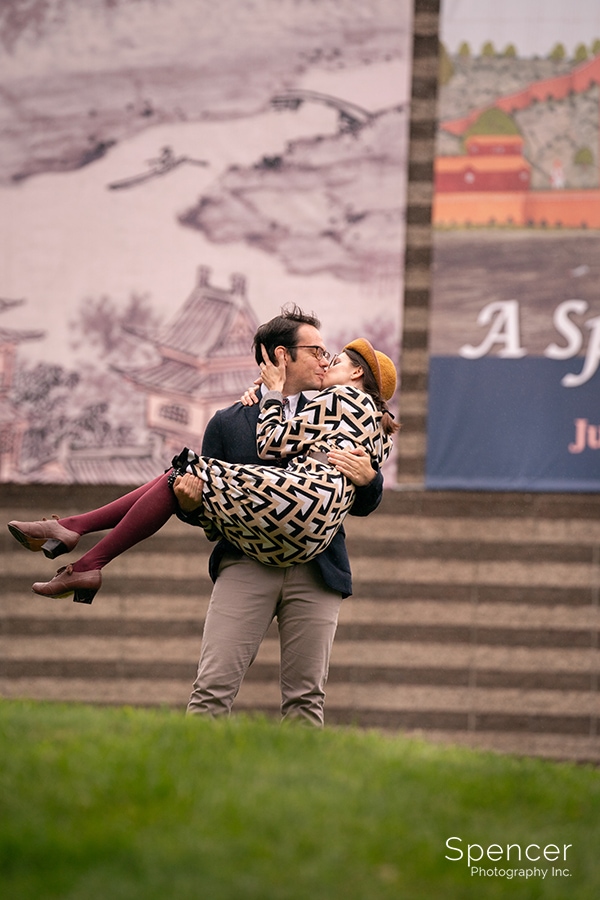 man kissing woman during summer engagement pictures at Cleveland Museum of Art