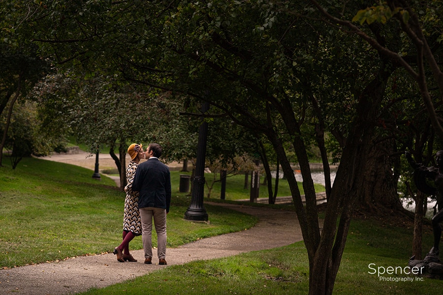 Couple kissing during summer engagement pictures at Cleveland Wade Oval Park