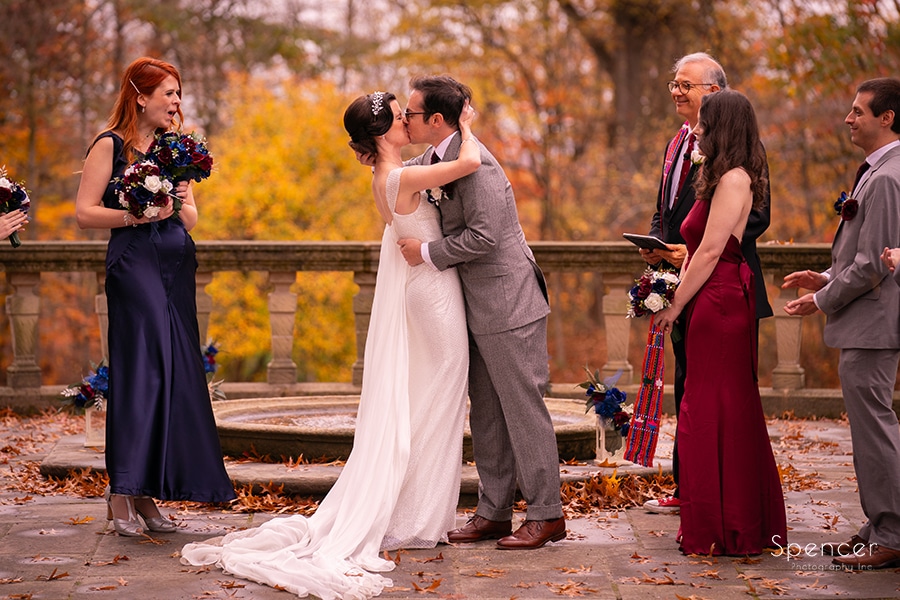 first kiss at wedding ceremony in birch alley at stan hywet
