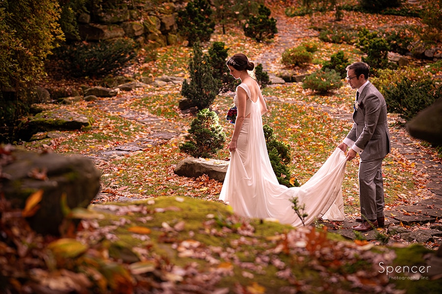 bride and groom walking in japanese garden at stan hywet