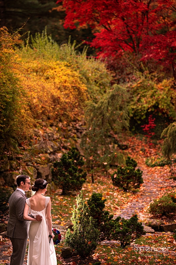 bride and groom standing in japanese garden at stan hywet