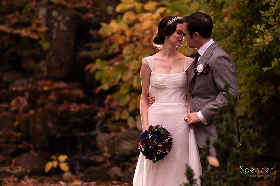 bride and groom kissing in japanese garden at stan hywet