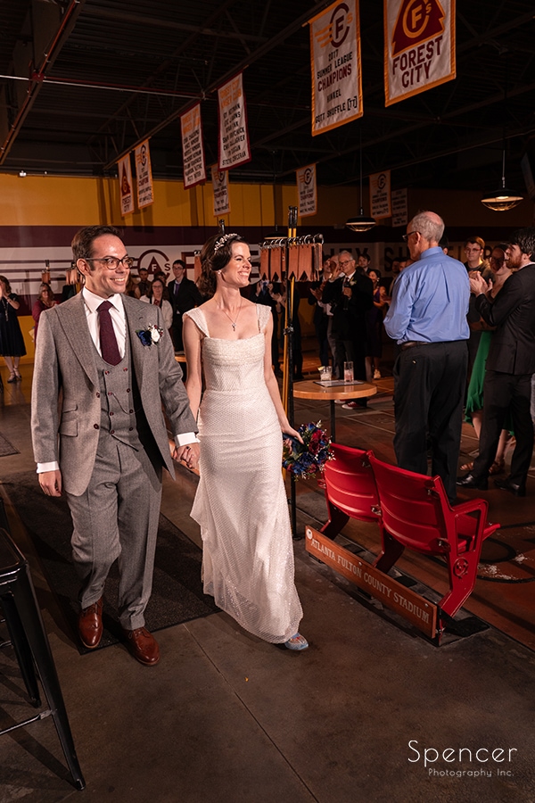 bride and groom entering unique wedding reception