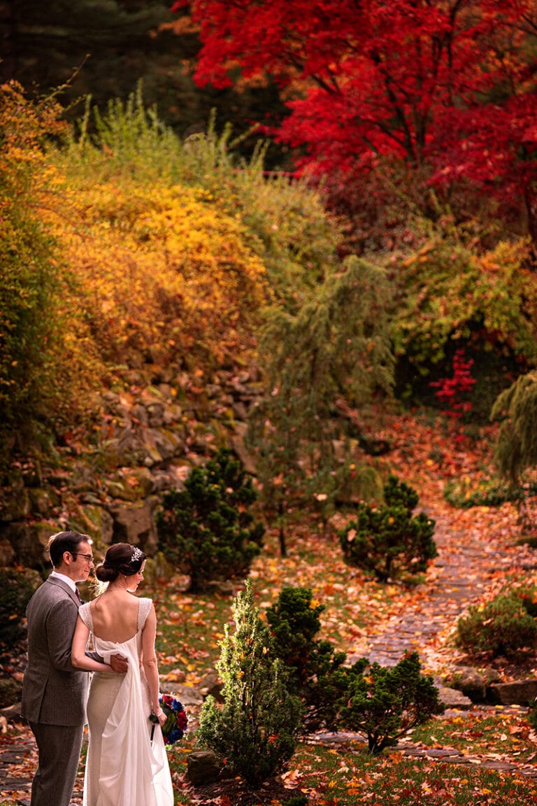 bride and groom walking in Japanese Garden at Stan Hywet
