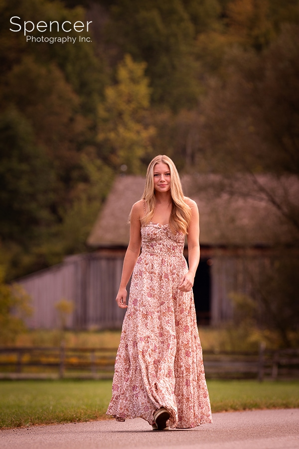 girl walking in her senior pictures at Hale Farm and Village