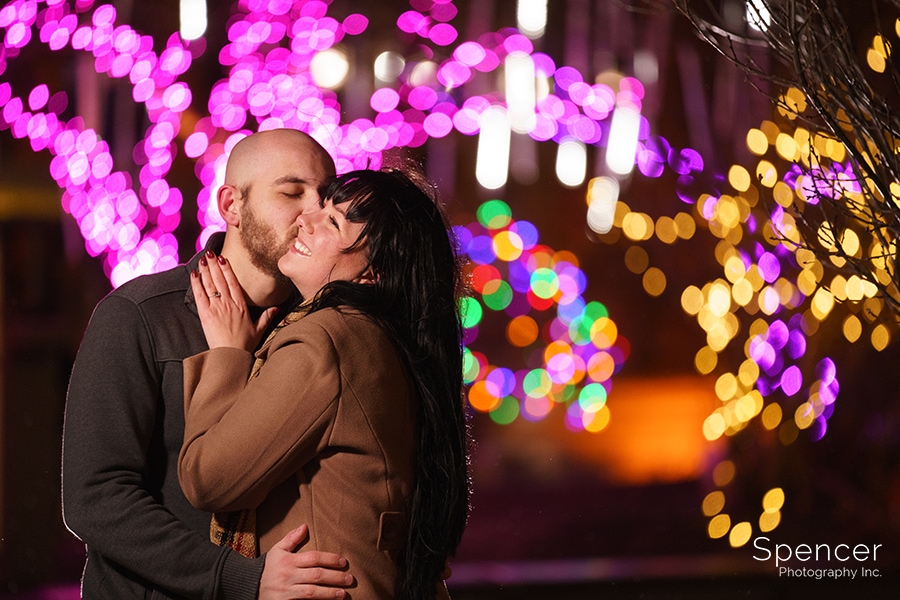 man kissing woman in Christmastime Engagement photo in Cleveland