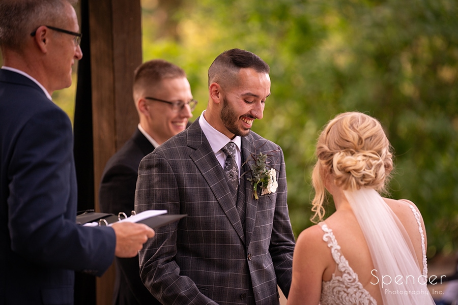 groom smiling during wedding ceremony at Landolls