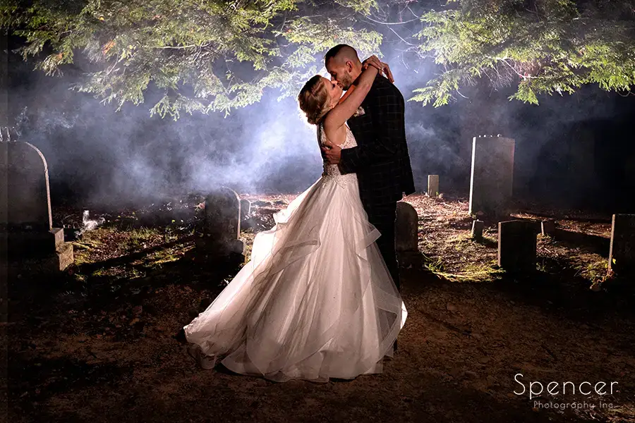 bride and groom kissing in graveyard at Landolls Mohican Castle wedding