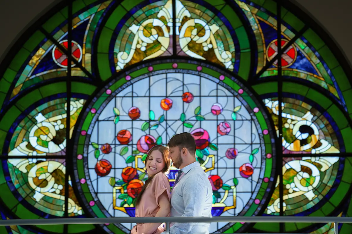 Engagement picture in front of stained glass at The Elliot Cleveland